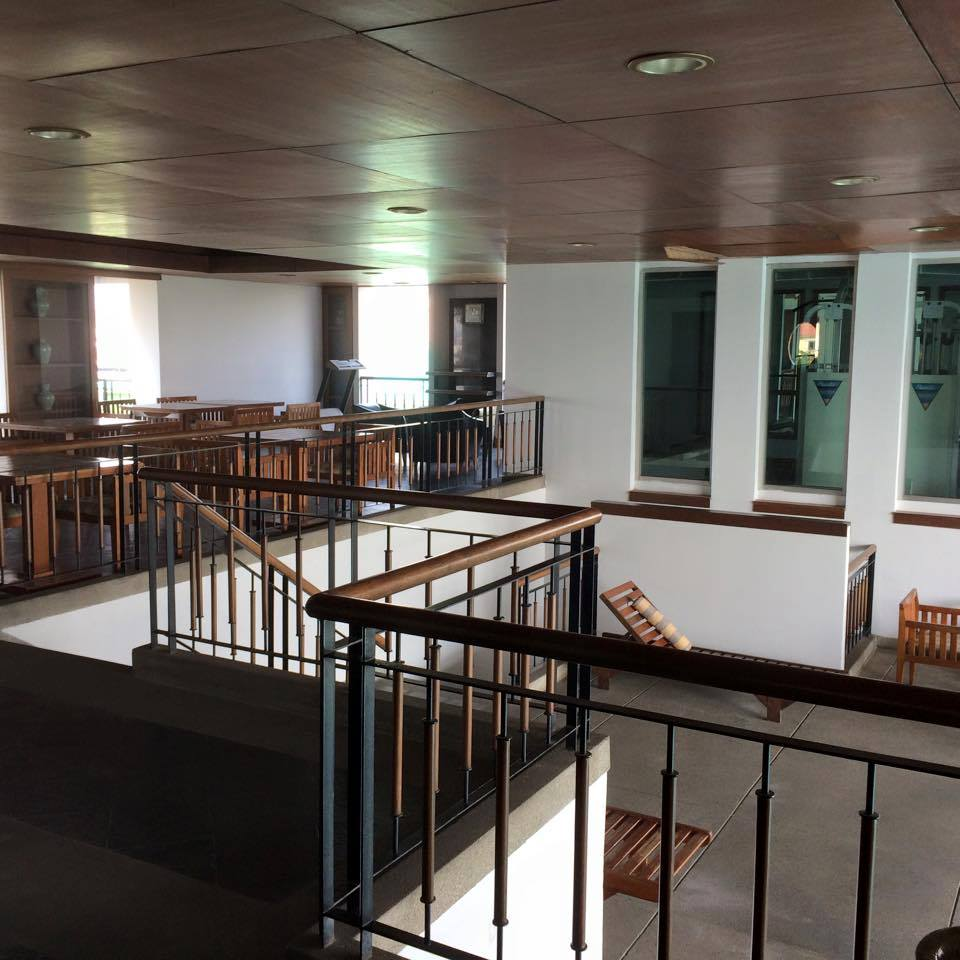 Interior corridors with wooden railings and natural light