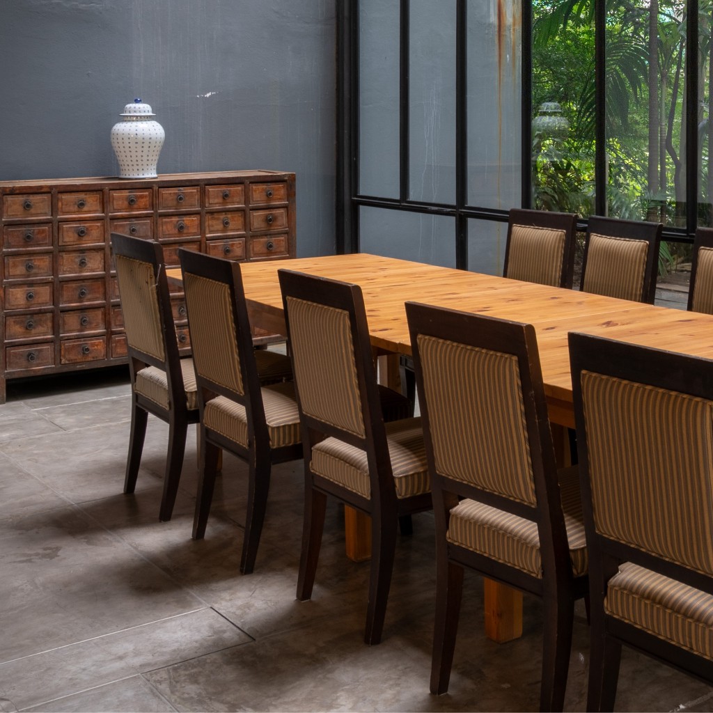 Dining room with long wooden table and upholstered chairs